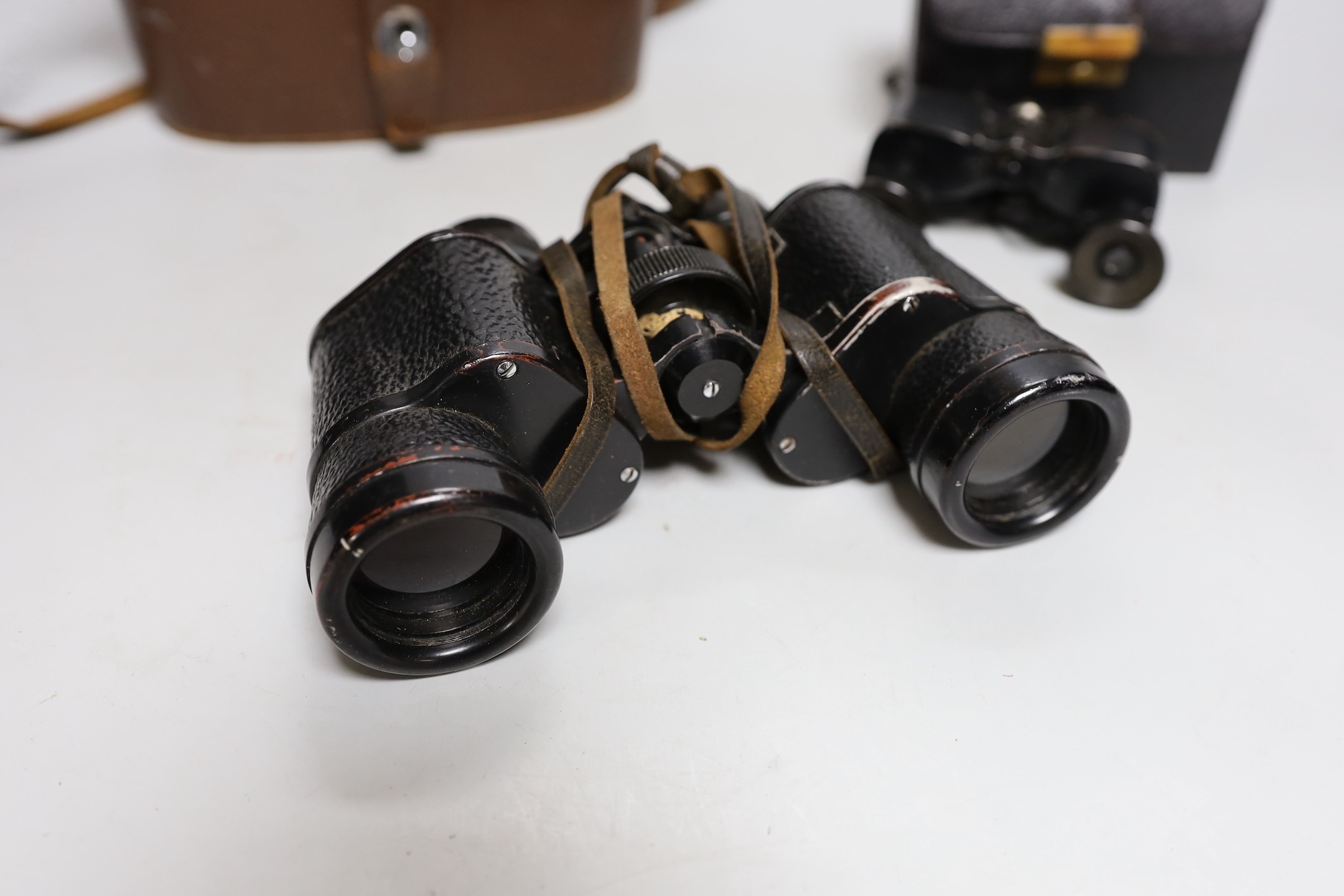 A cased set of Ross binoculars and a smaller cased set for racing